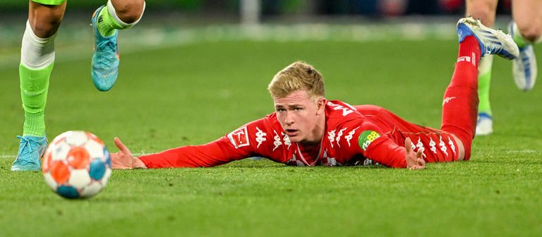 Der Mainzer Jonathan Burkardt liegt auf dem Boden - Wolfsburg war einfach stärker. (Foto: DASDING, IMAGO, IMAGO / Kirchner-Media)