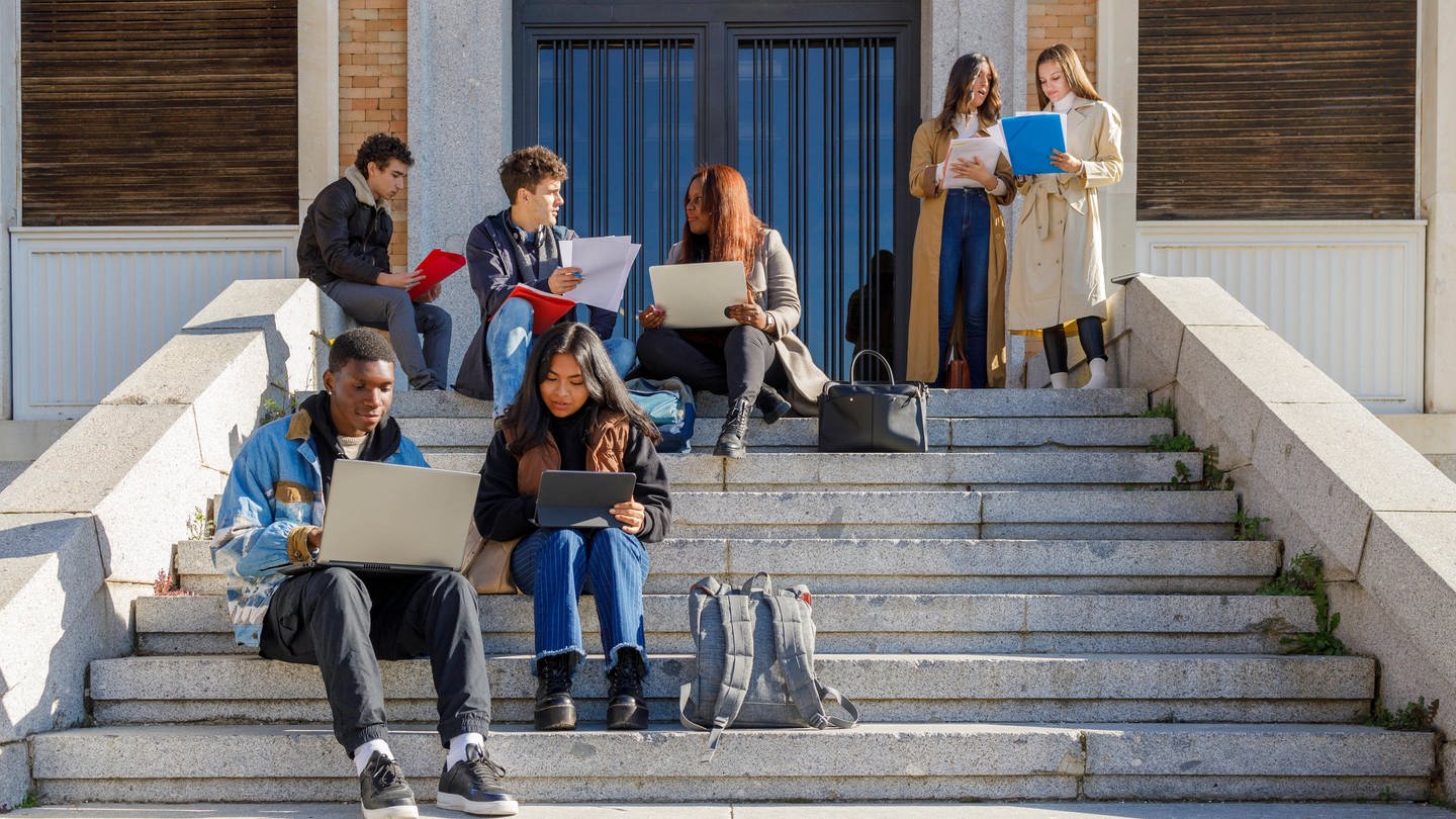 Studierende auf der Treppe vor der Universität. (Foto: IMAGO, IMAGO / Westend61)