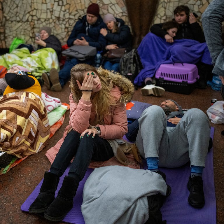 Menschen sitzen und liegen in einer U-Bahn-Station und nutzen diese als Bombenschutzraum. (Foto: dpa Bildfunk, picture alliance/dpa/AP | Emilio Morenatti)