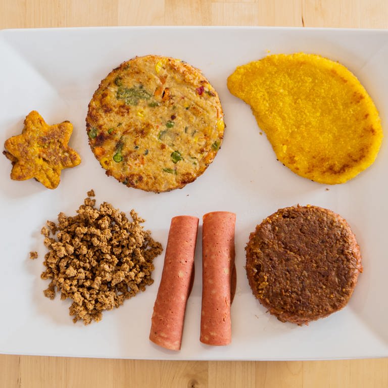 Verschiedene vegane und vegetarische Fleischersatzprodukte liegen auf einem Teller. (Foto: dpa Bildfunk, picture alliance/dpa | Andreas Arnold)