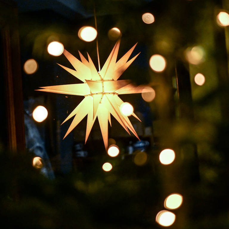 Ein leuchtender Weihnachtsstern hängt an einem Geschäft (Foto: dpa Bildfunk, picture alliance/dpa/dpa-Zentralbild | Britta Pedersen)