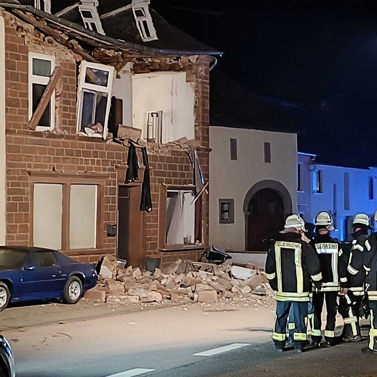 Feuerwehrleute stehen an der Einsatzstelle. In einem Einfamilienhaus in Spangdahlem im Eifelkreis Bitburg-Prüm hat es eine Explosion gegeben (Foto: dpa Bildfunk, picture alliance/dpa/Steil-TV | -)