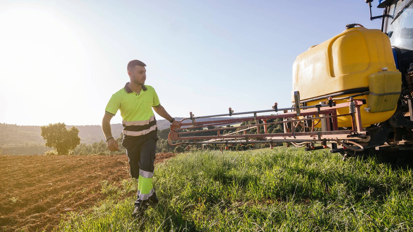 Farmer adjusting crop sprayer on field on sunny day model released, Symbolfoto (Foto: IMAGO, IMAGO / Westend61)