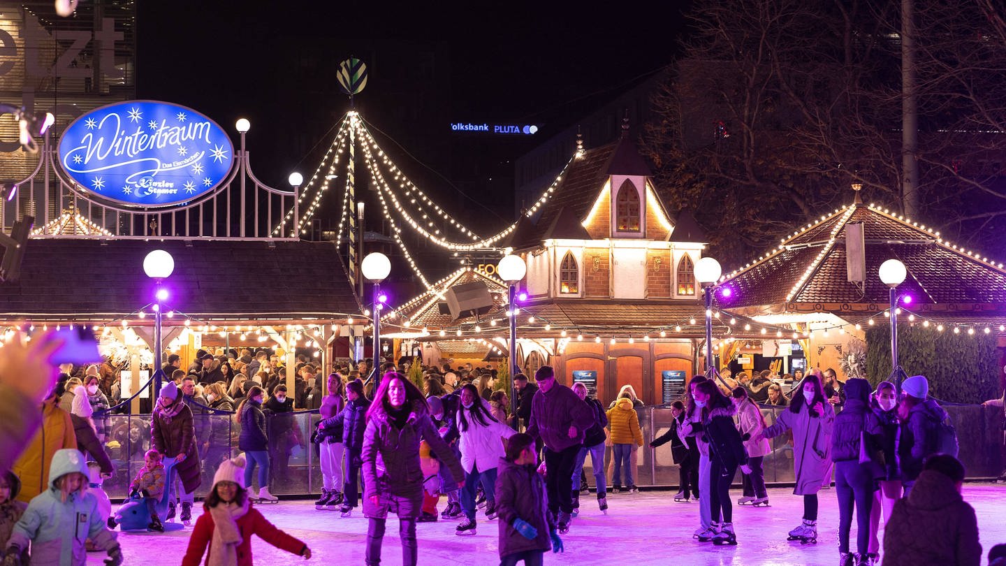 Menschen fahren Schlittschuh auf einer Eisfläche beim Stuttgarter Wintertraum