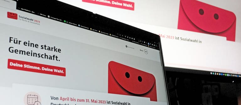 Eine Internetseite zur Sozialwahl 2023 ist auf zwei Computermonitoren zu sehen. Rund 52 Millionen Menschen in Deutschland sind zur Teilnahme an der Sozialwahl aufgerufen - davon erstmals 22 Millionen online. (Foto: dpa Bildfunk, picture alliance/dpa | Stefan Jaitner)
