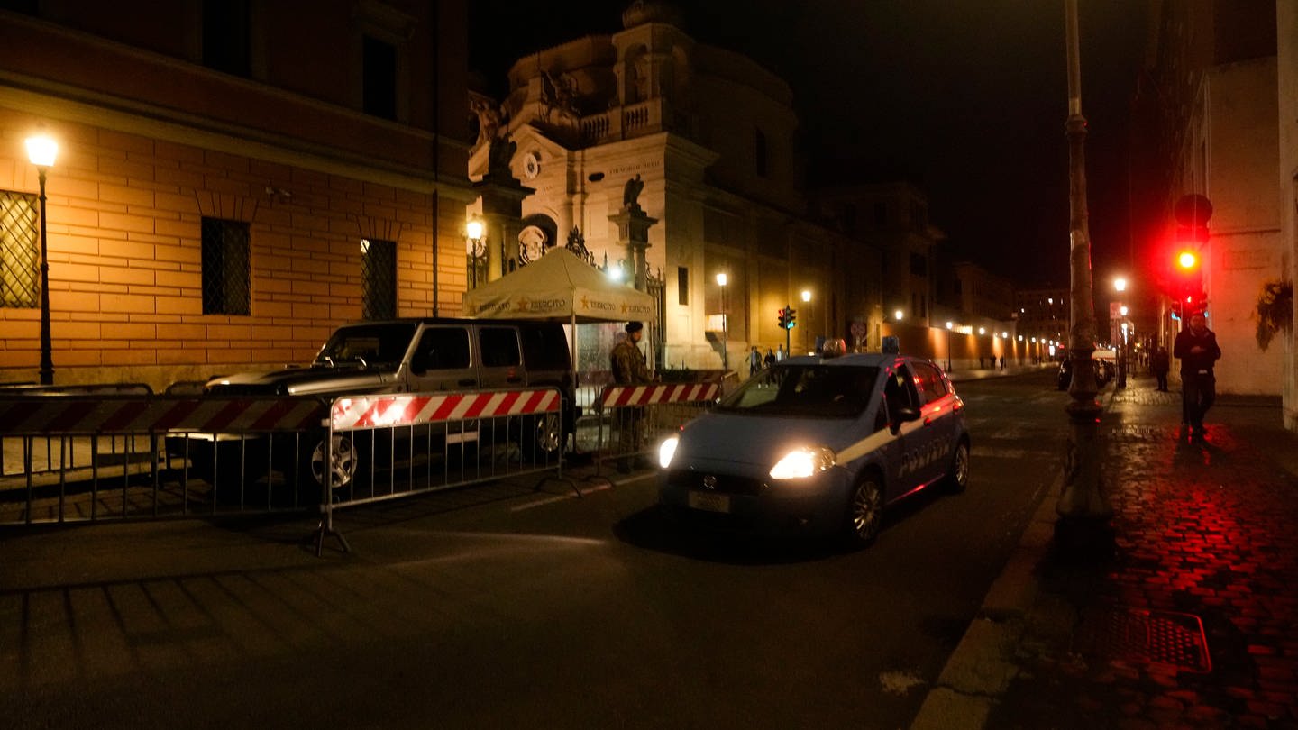 Ein italienisches Polizeiauto fährt am späten Donnerstag vor dem Santa-Anna-Tor im Vatikan vorbei. Ein Auto, das von einer Person mit offensichtlichen psychiatrischen Problemen gesteuert wurde, raste am Donnerstagabend durch das Santa-Anna-Tor und raste an den Schweizergardisten vorbei. (Foto: dpa Bildfunk, picture alliance/dpa/AP | Andrew Medichini)