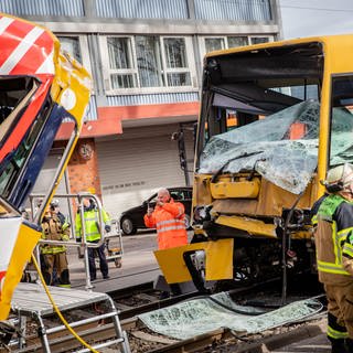 Einsatzkräfte der Feuerwehr arbeiten an zwei zerstörten Stadtbahnen. Bei dem Zusammenstoß zweier Stadtbahnen im Stuttgarter Stadtteil Wangen sind mehrere Menschen verletzt worden. (Foto: dpa Bildfunk, picture alliance/dpa | Christoph Schmidt)