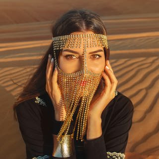 Frau in der Wüste mit "Desert Eyes Makeup" und Strass-Burka. (Foto: IMAGO, IMAGO / Pond5 Images)