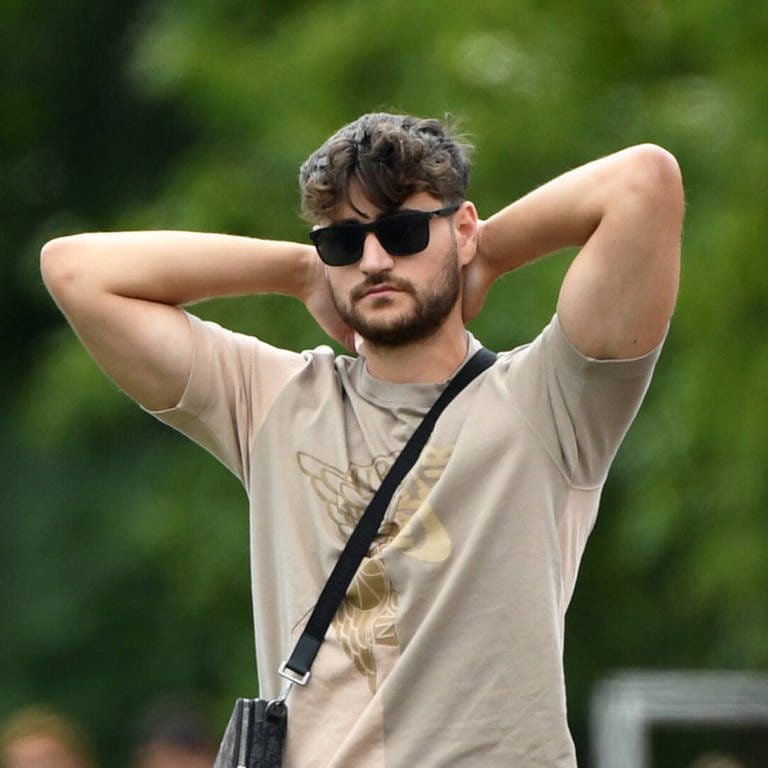 Elias Nerlich steht mit einer Sonnenbrille auf einem Fußballplatz  (Foto: IMAGO, IMAGO / Matthias Koch)