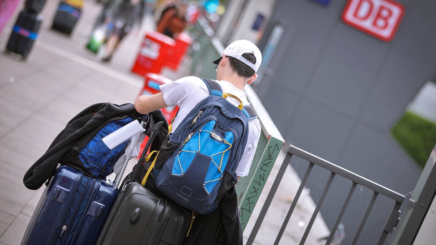 Ein junger Mann ist mit seinem Gepäck am Hamburger Hauptbahnhof unterwegs (Foto: IMAGO, IMAGO / Maximilian Koch)