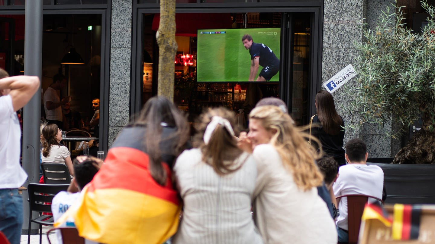 Fußball: EM, England - Deutschland, Achtelfinale. Fans sitzen in einem Restaurant und schauen das Spiel auf einem Fernseher, in dem Deutschlands Thomas Müller nach einer vergebenen Chance auf dem Boden kniet. (Foto: dpa Bildfunk, picture alliance/dpa | Jonas Güttler)